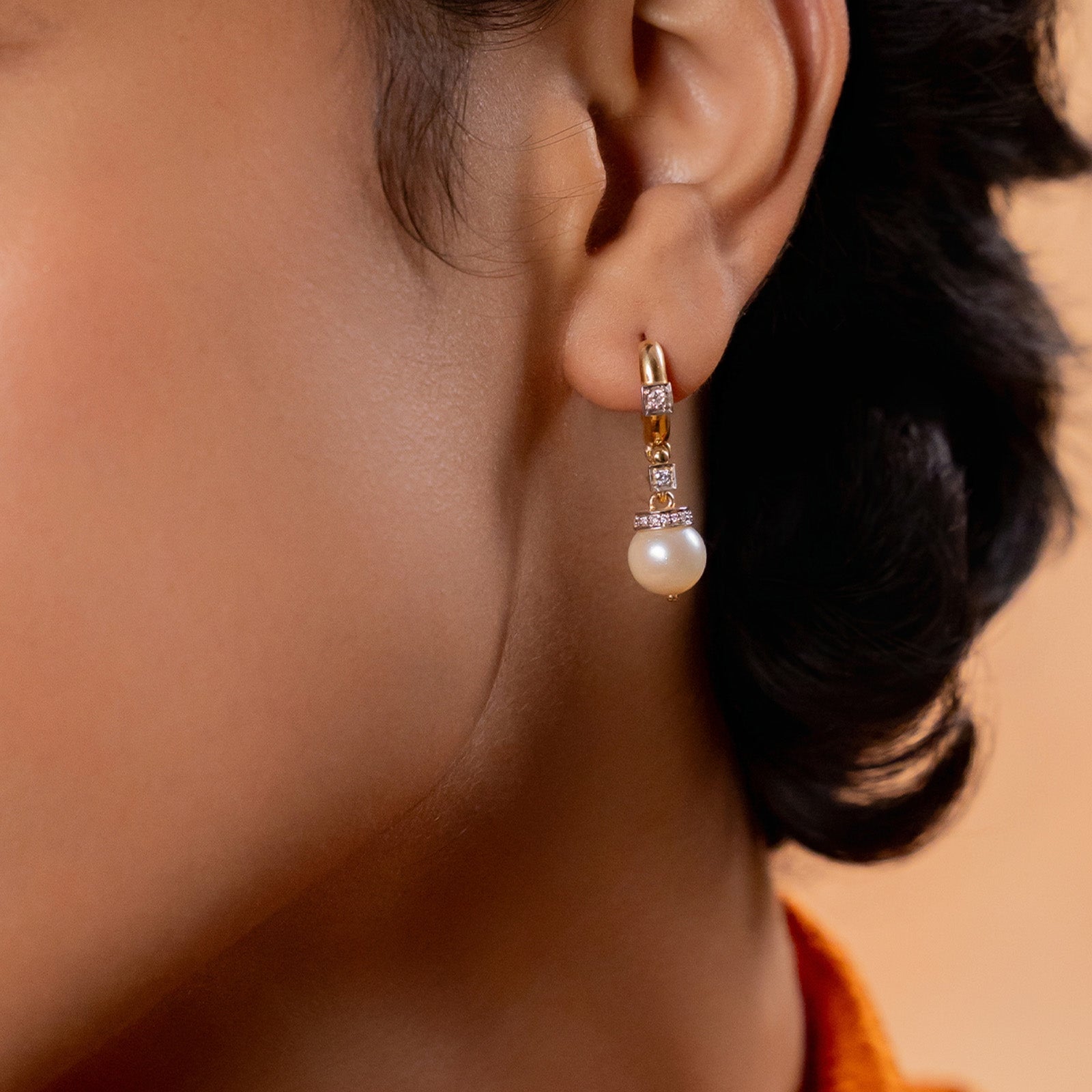 Shae Earrings in 14K gold with cultured pearl drops suspended from natural brilliant-cut diamond-set huggie hoops