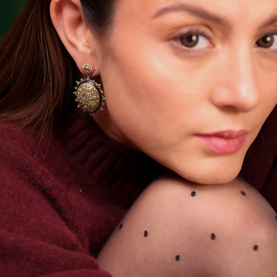 Sunburst earrings featuring pavé sapphires in warm, sun-kissed hues with faceted Green Amethyst stud tops.