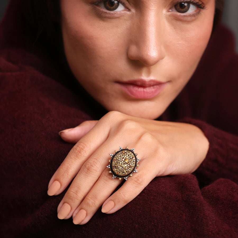 Elegant cocktail ring featuring sunlit sapphires and an enamel band.