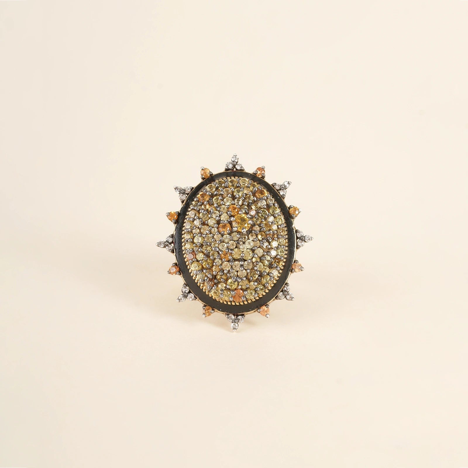 Elegant cocktail ring featuring sunlit sapphires and an enamel band.