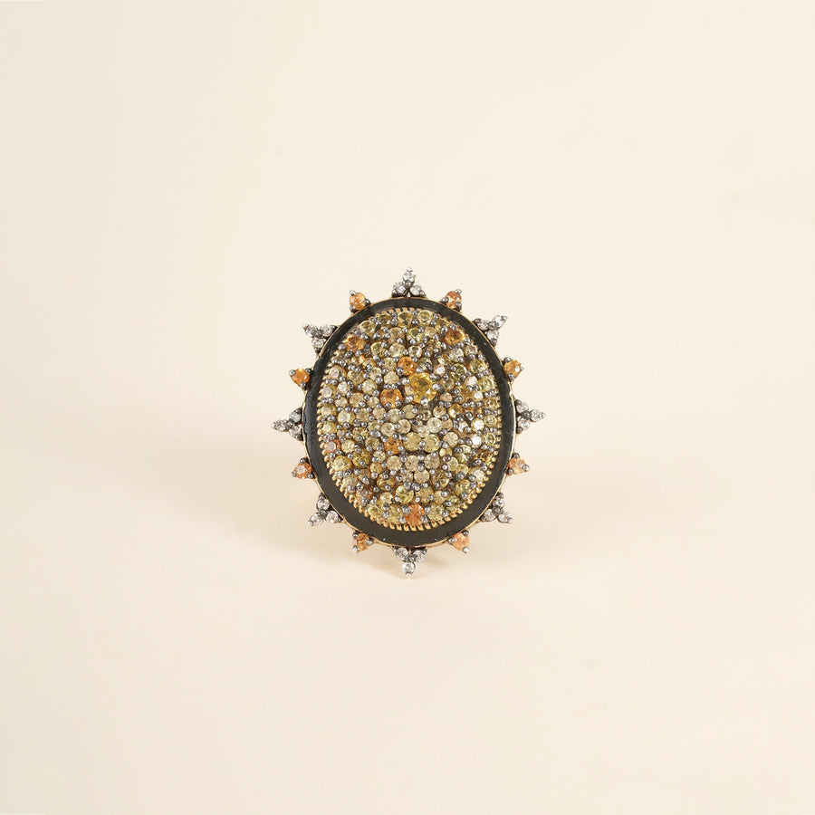 Elegant cocktail ring featuring sunlit sapphires and an enamel band.