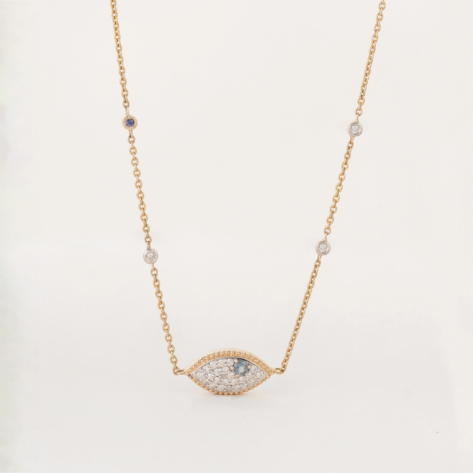 Evil Eye Necklace in 14K gold with blue topaz evil eye pendant and natural brilliant-cut diamonds