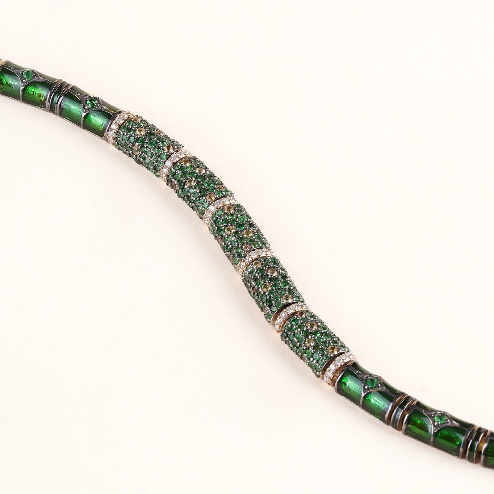Evra Forest Bracelet in 14K gold and 925 silver with sapphire and tsavorite pavé half-barrel units, brilliant-cut diamond spacers, and green enamel back detail 