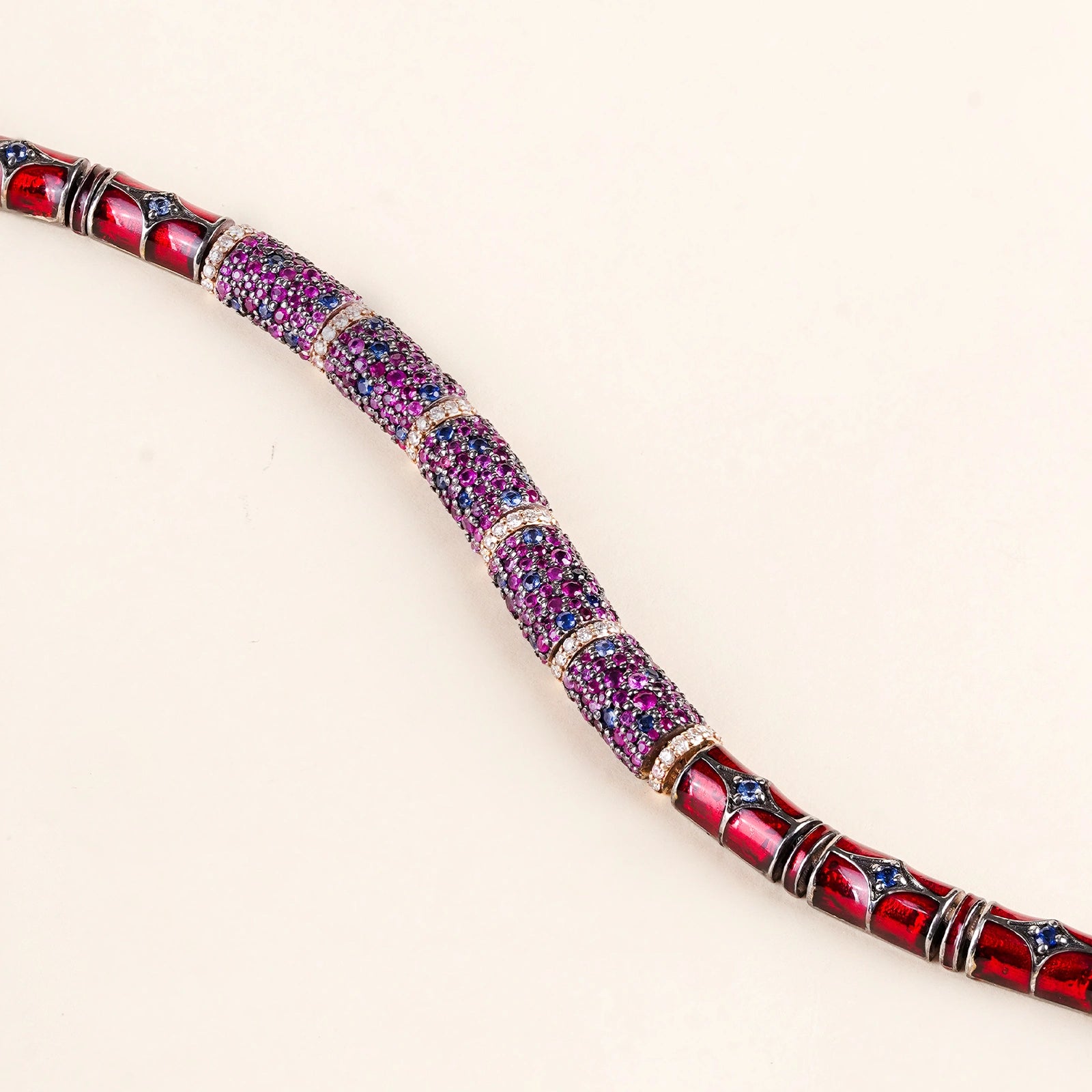 Evra Orchid Bracelet in 14K gold and 925 silver with sapphire and ruby pavé half-barrel units, brilliant-cut diamond, and red enamel back detail