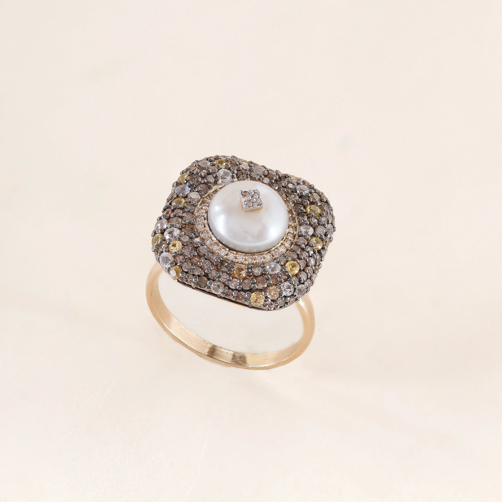Gwen Ring in 14K gold and 925 silver with cultured pearl centre, natural rose-cut diamonds, sapphires and black enamel