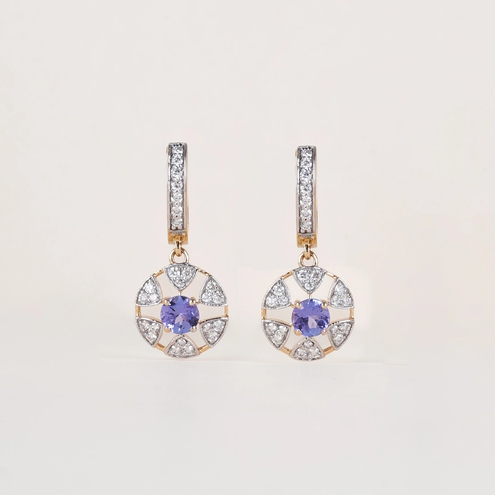 Laura Earrings in 14K gold with tanzanite centre stone in a floral-inspired setting framed by natural brilliant-cut diamonds