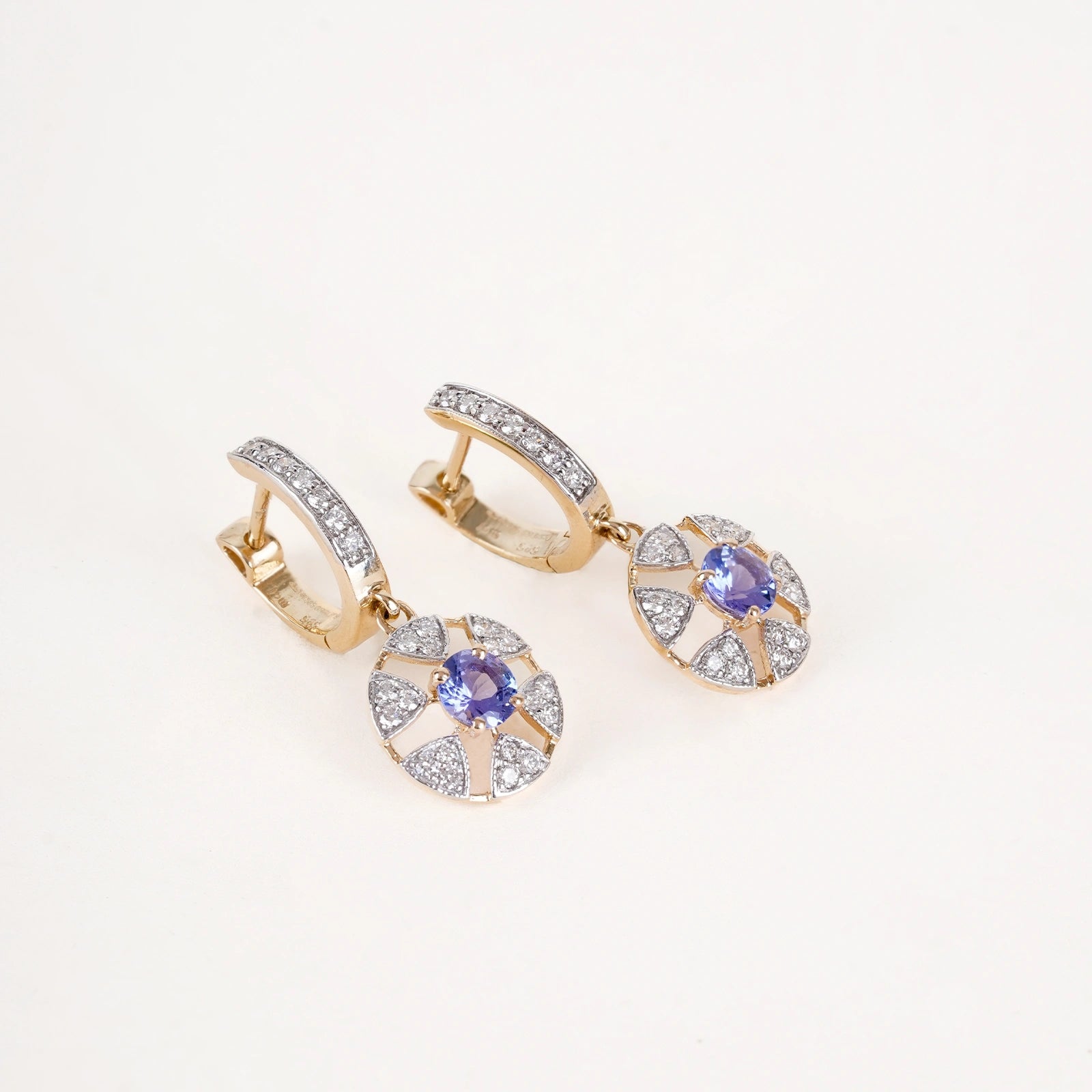 Laura Earrings in 14K gold with tanzanite centre stone in a floral-inspired setting framed by natural brilliant-cut diamonds