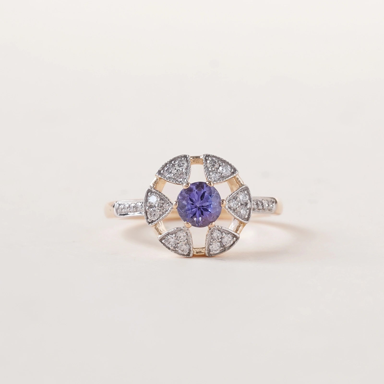 Laura Ring in 14K gold with tanzanite centre stone in a floral-inspired setting framed by natural brilliant-cut diamonds