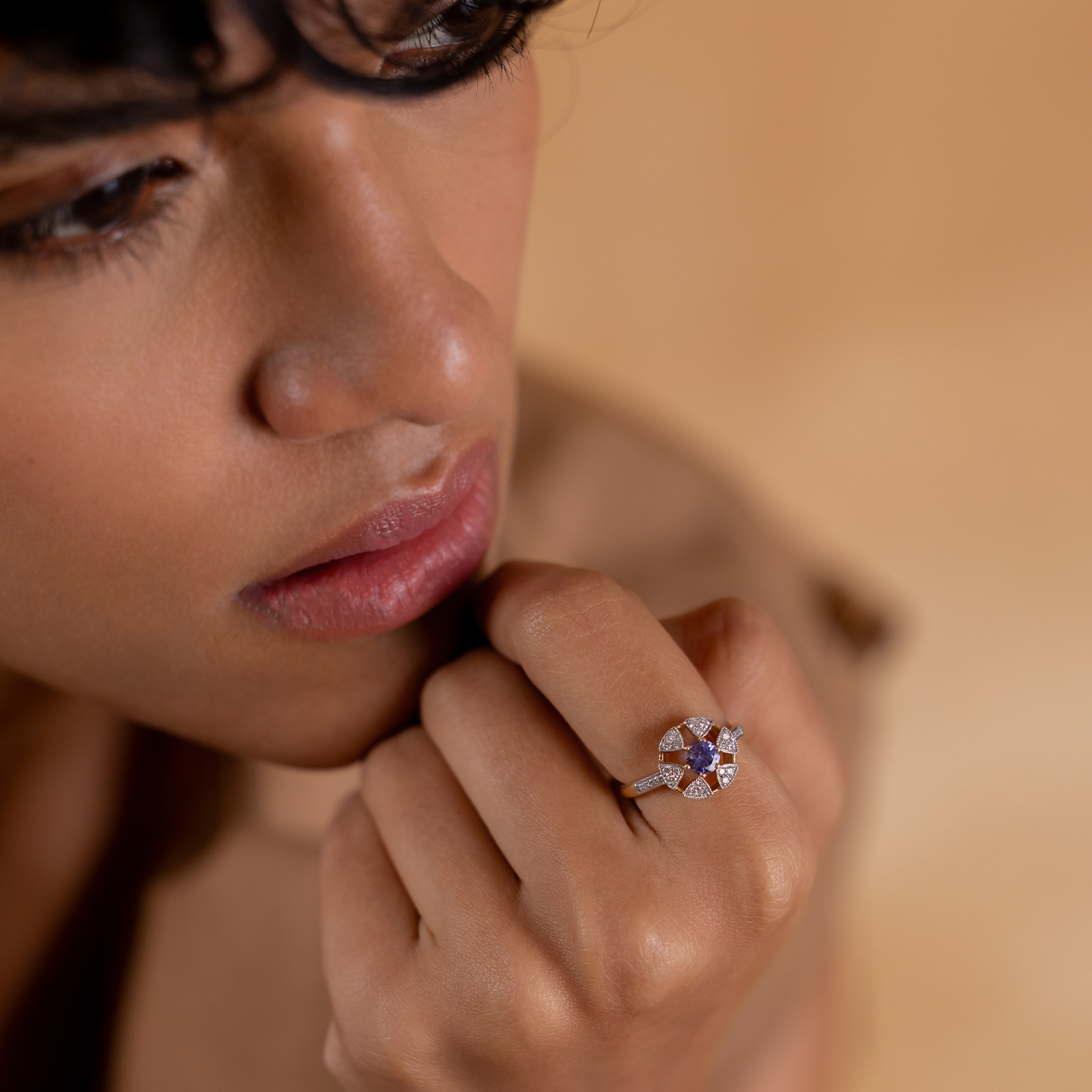 Laura Ring in 14K gold with tanzanite centre stone in a floral-inspired setting framed by natural brilliant-cut diamonds
