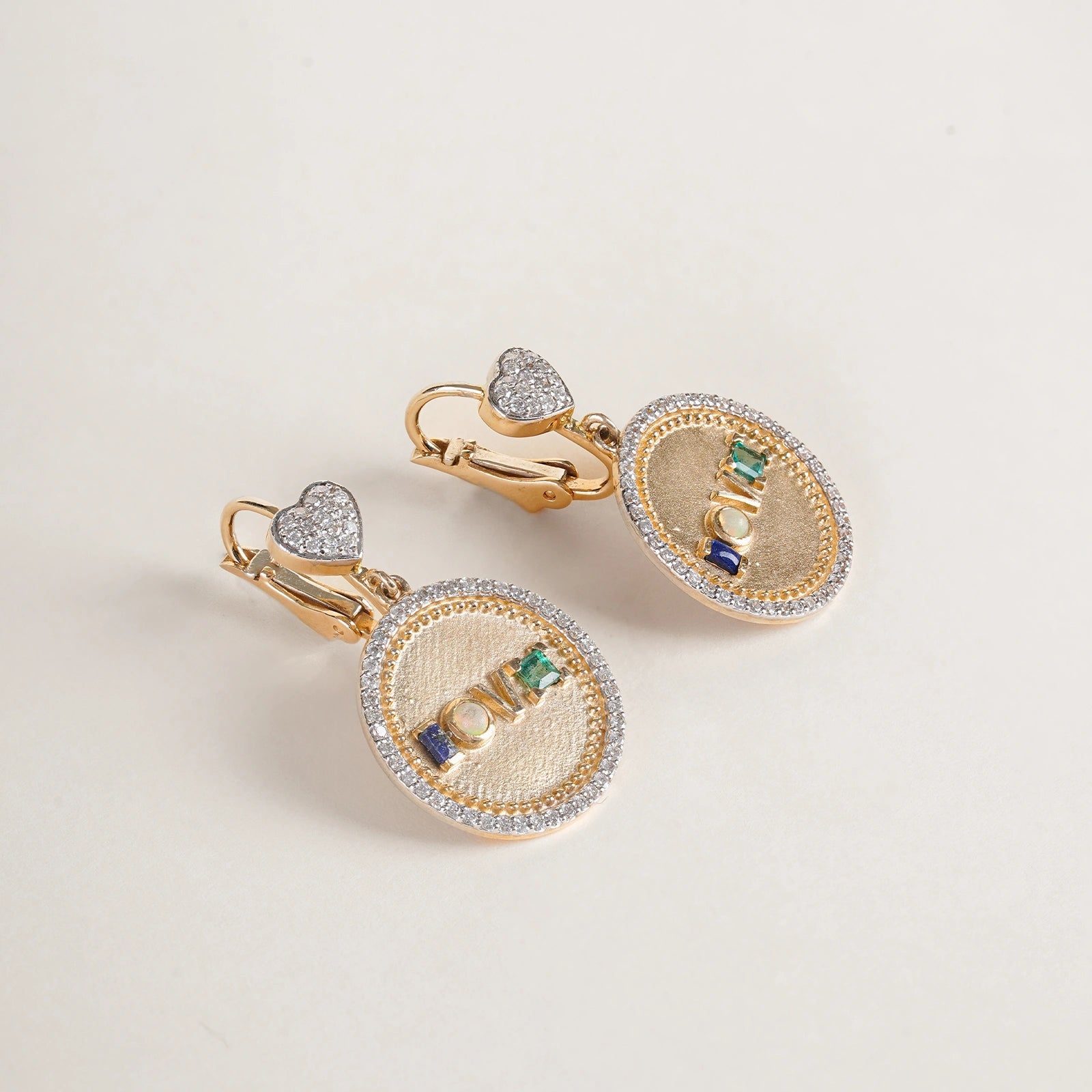 Fine 14K gold medallion earrings with diamond detailing and Victorian acrostic gemstone design.