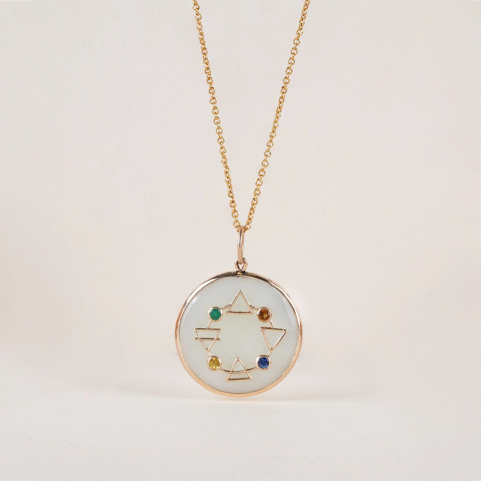 Maya Elements of Life Pendant in 14K gold with emerald, hessonite, yellow sapphire and blue sapphire on a serpentine base with coloured enamel