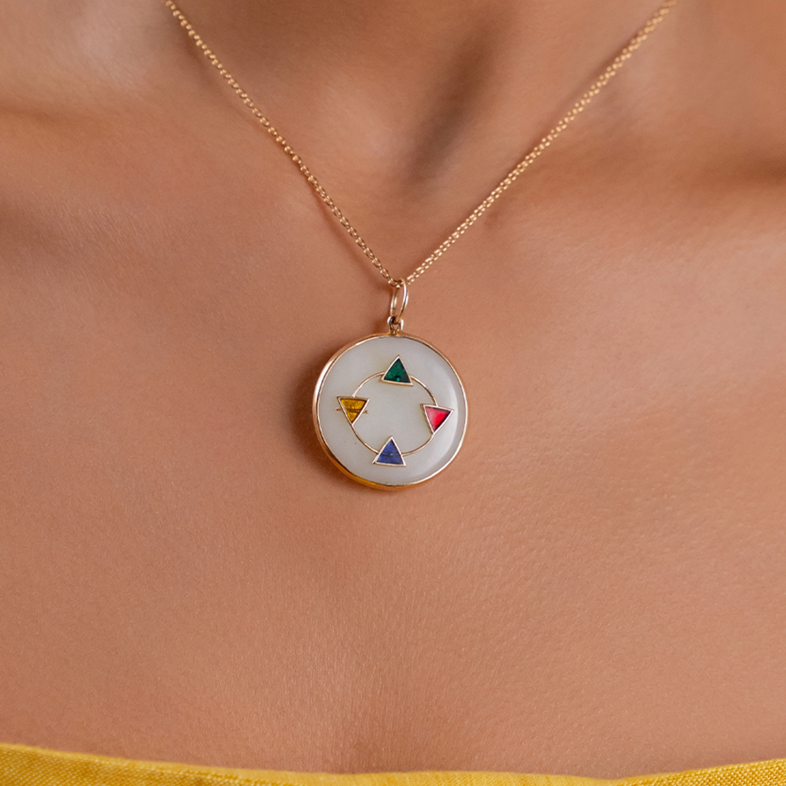 Maya Elements of Life Pendant in 14K gold with emerald, hessonite, yellow sapphire and blue sapphire on a serpentine base with coloured enamel