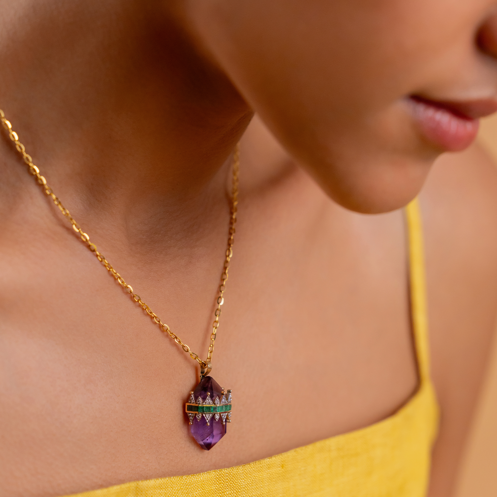 Promise Mini Pendant Necklace in yellow gold with crystal-cut purple amethyst crowned by a diamond and emerald tiara on an omega chain