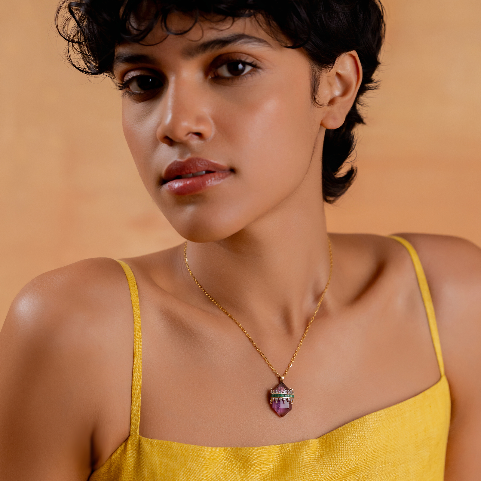 Promise Mini Pendant Necklace in yellow gold with crystal-cut purple amethyst crowned by a diamond and emerald tiara on an omega chain