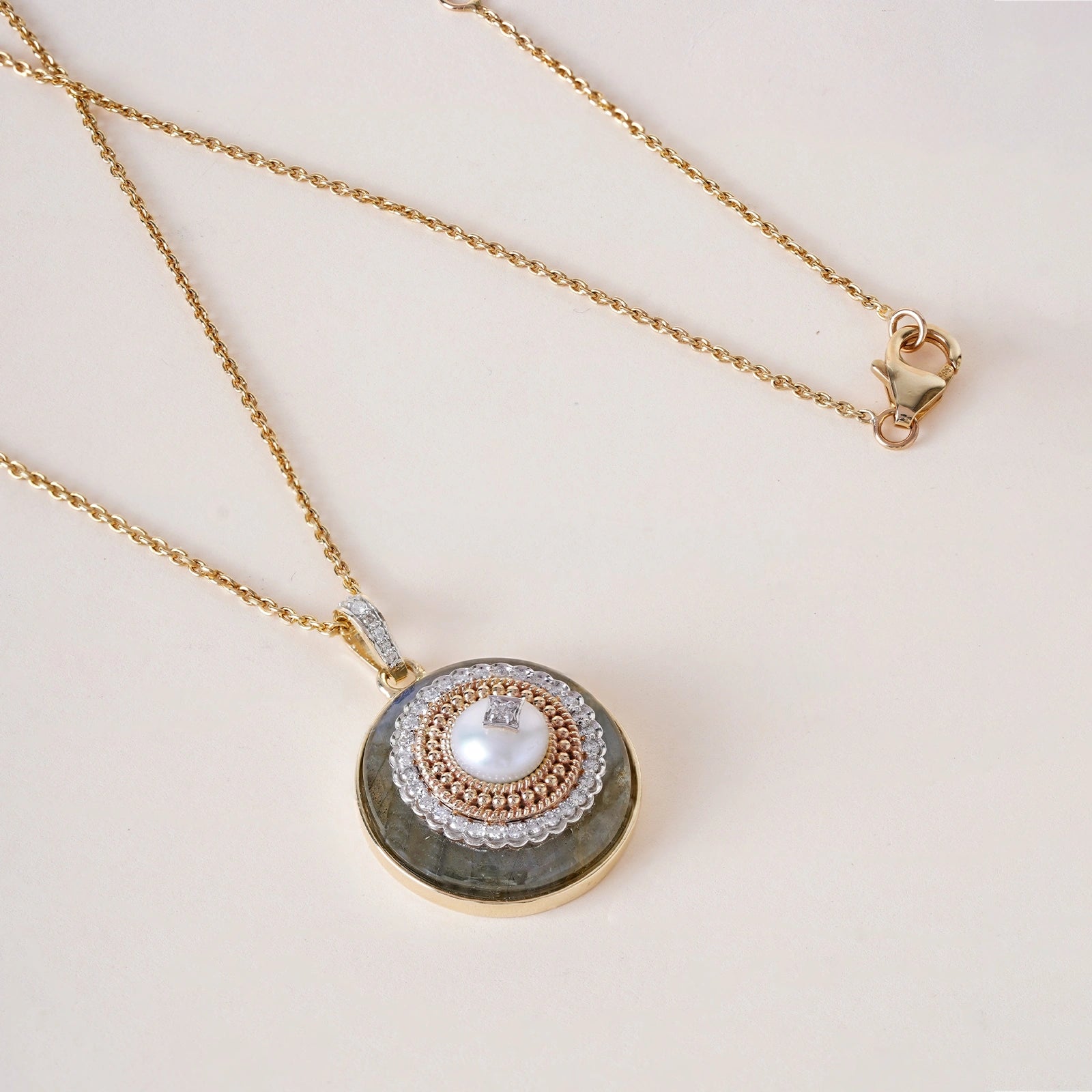 Rae Pendant Necklace in 14K gold with cultured pearl and natural brilliant-cut diamonds on a labradorite base with textured gold detail