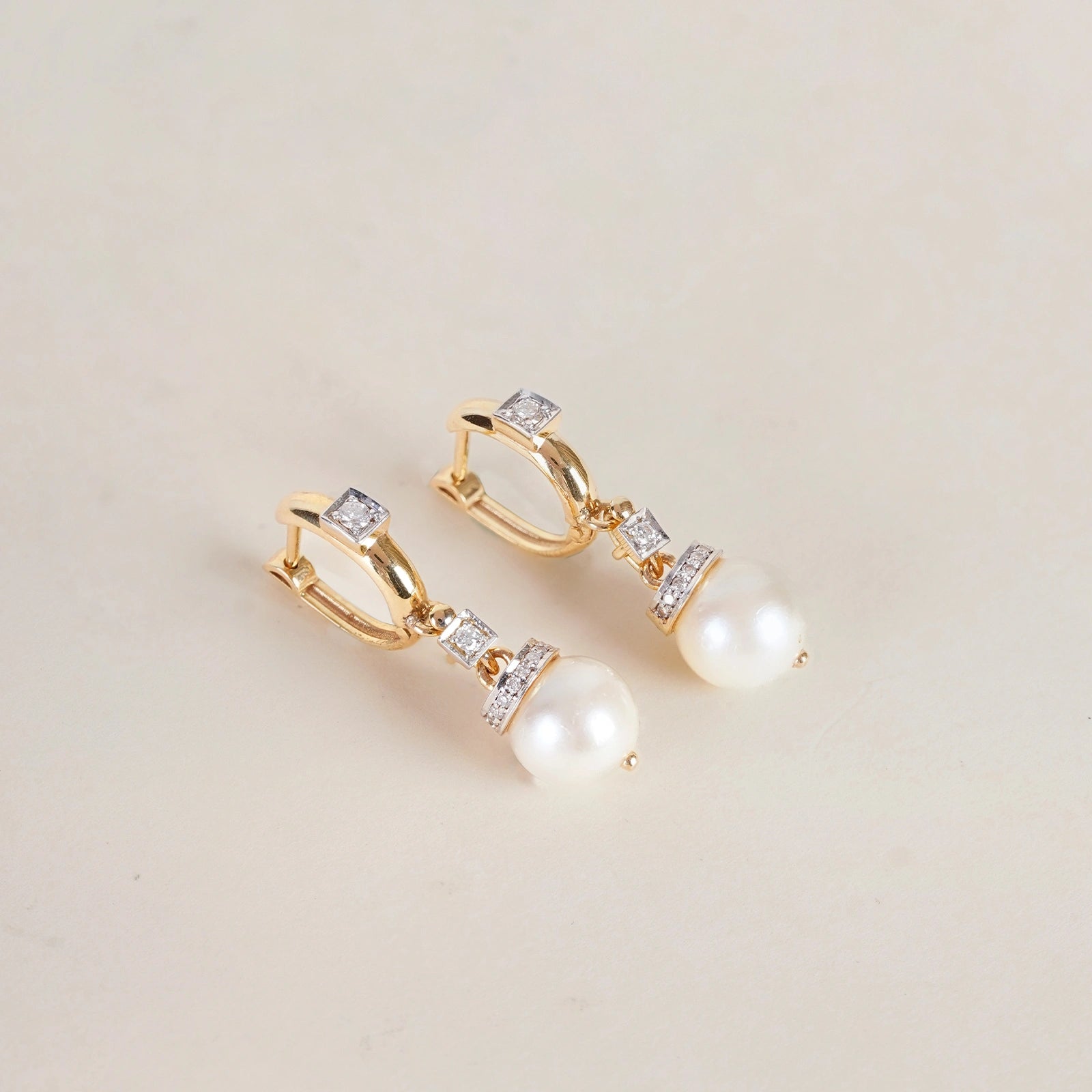 Shae Earrings in 14K gold with cultured pearl drops suspended from natural brilliant-cut diamond-set huggie hoops