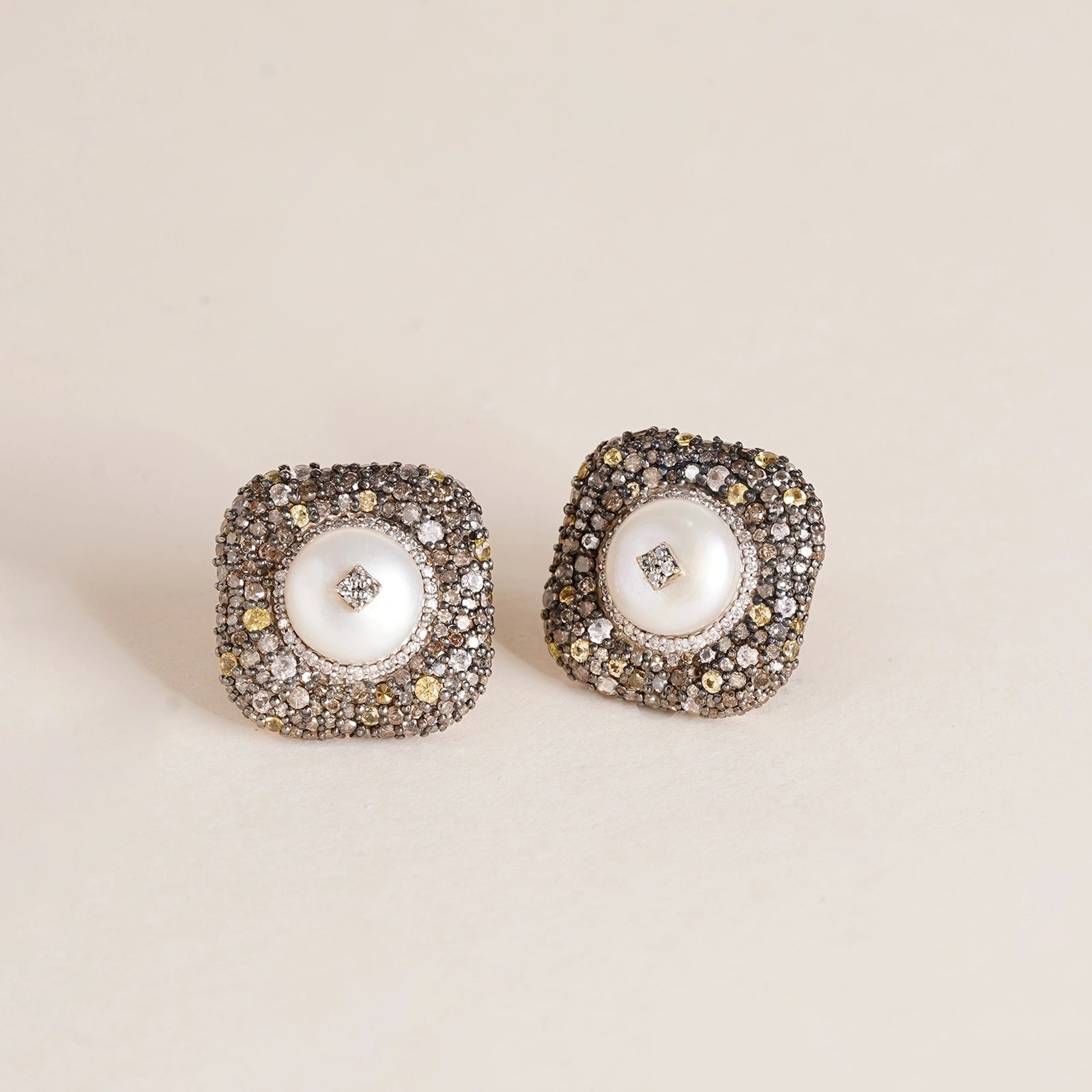 Gwen Ear Studs in 14K gold and 925 silver with cultured pearl centre, natural rose-cut diamonds, sapphires and black enamel